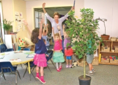 BARBARAELLEN KOCH FILE PHOTOEarly childhood education teacher Alison Aldredge leads her students as they act out growing from seeds to trees at Peconic Community School in 2013.